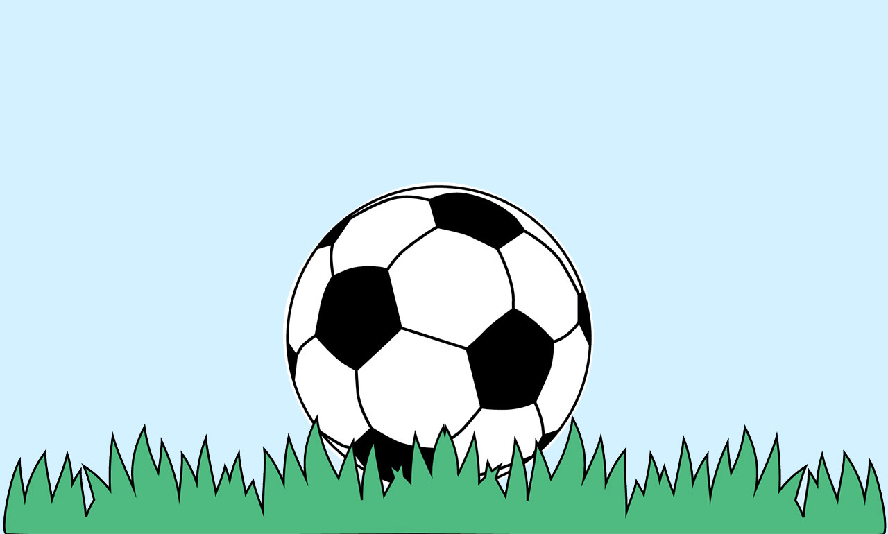 A football laying on grass.